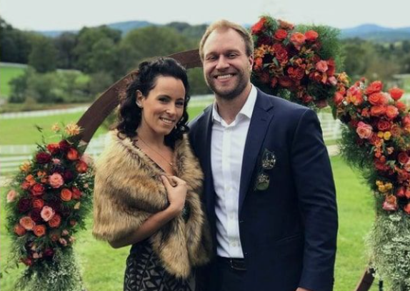 Furious Pete wife Melissa Czerwinski in a fur shawl smiling with Peter Czerwinski at an outdoor wedding event.

