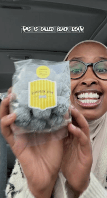 Black Death Sour Candy Challenge: 60s of Lethal Grit A TikTok creator holding a bag of Black Death sour candy, the world’s most extreme sour challenge.